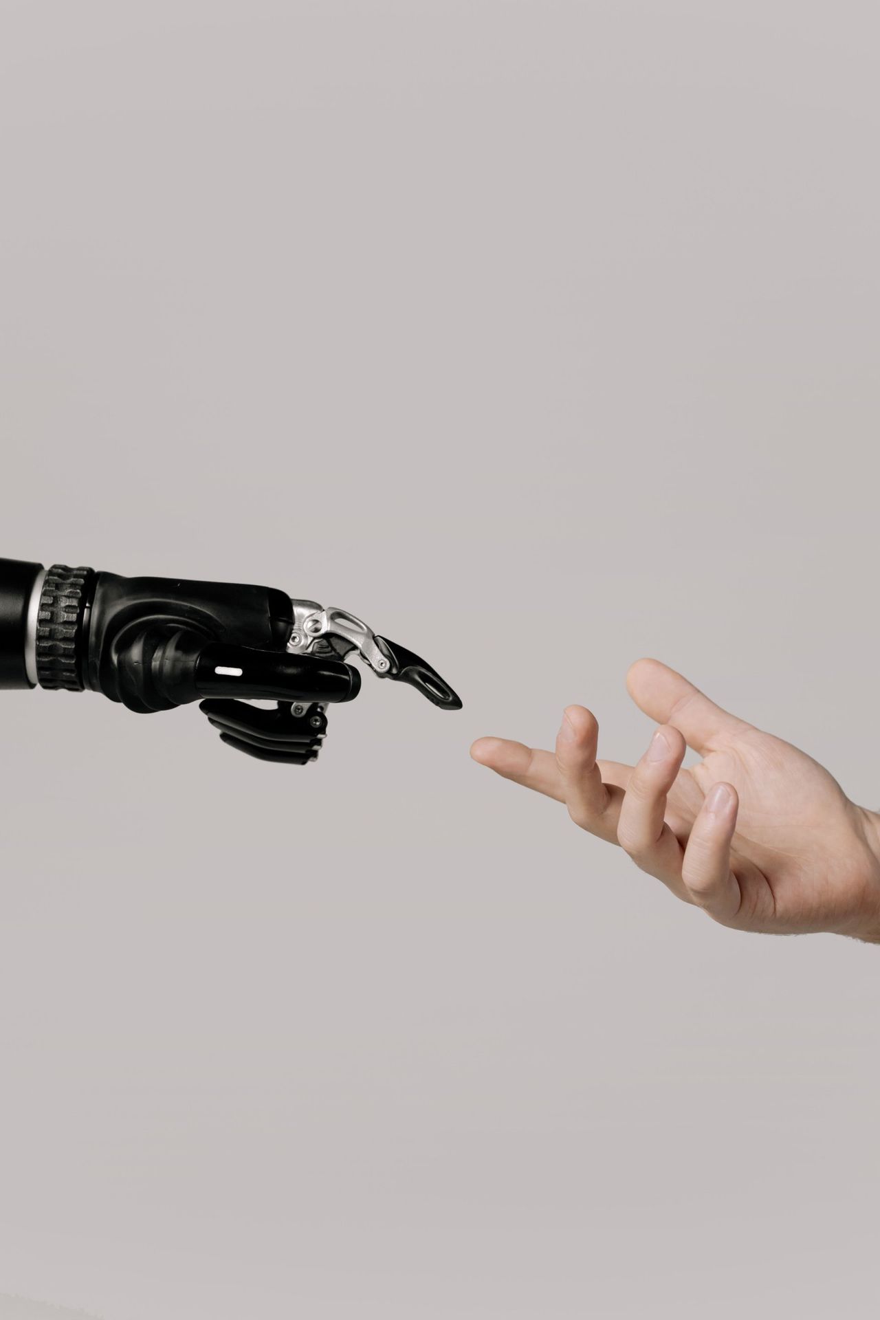 Robot hand reaching toward a human hand, symbolizing collaboration between AI systems and hotel staff